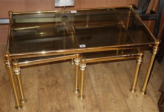 A nest of three modern gilt metal and smoked glass occasional tables W.90cm
